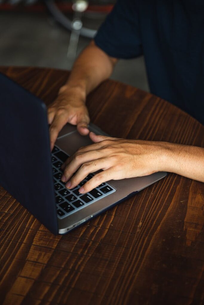 pexels-photo-5472303 Crop unrecognizable man using contemporary laptop